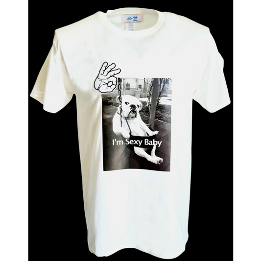 White t-shirt featuring a black and white graphic of a bulldog sitting on a swing with the text "I'm Sexy Baby" and a hand making an "OK" gesture above