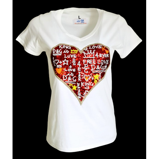 White t-shirt with a large heart-shaped sequin design featuring graffiti-style text and symbols in red and gold