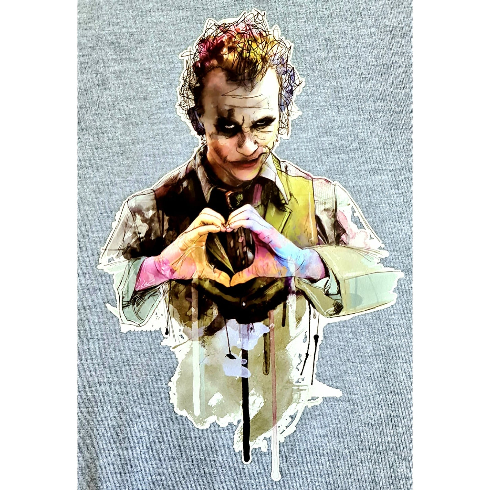 Heather grey t-shirt featuring a graphic design of two iconic interpretations of the Joker blended into one image