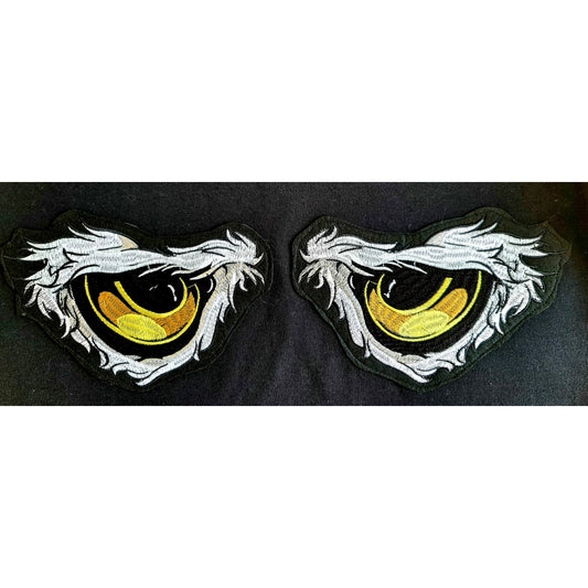 Black t-shirt featuring a design of yellow eyes with white detailing, creating a mysterious and captivating look