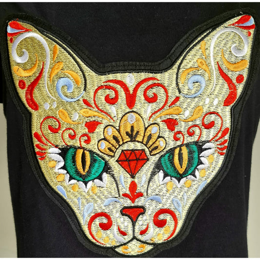 Black t-shirt with a vibrant, intricately embroidered cat face featuring colorful patterns and green eyes